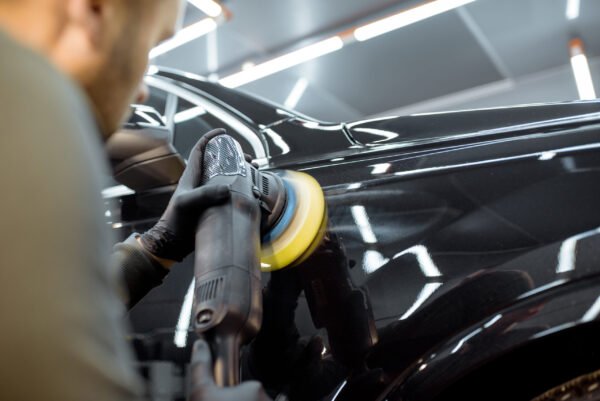 Worker polishing the car
