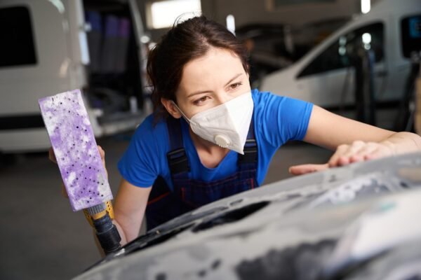 Worker checking car body