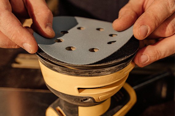 Worker assembling mesh abrasive disc