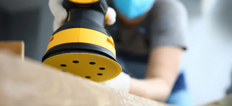 Worker sanding the surface