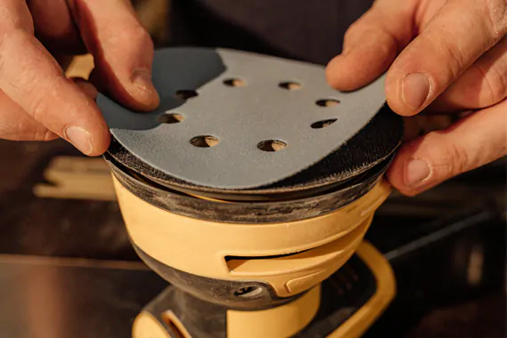 Worker assembling mesh abrasive disc
